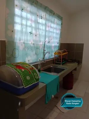 a bathroom with a sink and a shower curtain at Eleven Homestay Kuala Kangsar in Kuala Kangsar