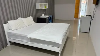 a hospital bed with white sheets and pillows at Summer Hotel Kampar Perak in Kampar