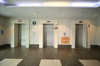 a hallway with three elevators in a building at Kingston Hotel 15 - Tower Regency, Ipoh in Ipoh