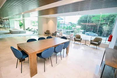 a dining room with a wooden table and chairs at Kingston Hotel 15 - Tower Regency, Ipoh in Ipoh