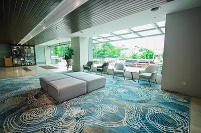 a lobby with a couch and chairs on a carpet at Kingston Hotel 15 - Tower Regency, Ipoh in Ipoh