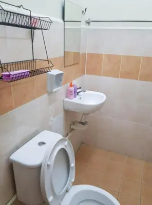 a bathroom with a toilet and a sink at Mumtaz Homestay in Kampong Belah Dua