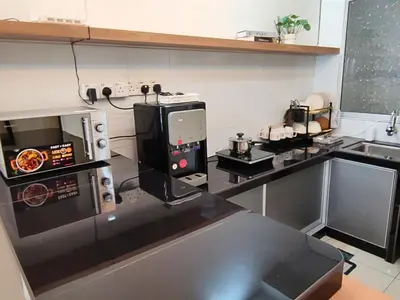 a kitchen with a counter with a microwave and a stove at Majestic Sanctuary Homestay Taiping with Netflix - 2 Carpark in Taiping