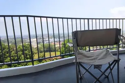a chair sitting on top of a balcony with a view at Majestic Sanctuary Homestay Taiping with Netflix - 2 Carpark in Taiping