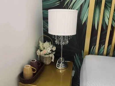 a lamp on a table next to a bed at Cozy Private Room Teluk Intan in Teluk Intan