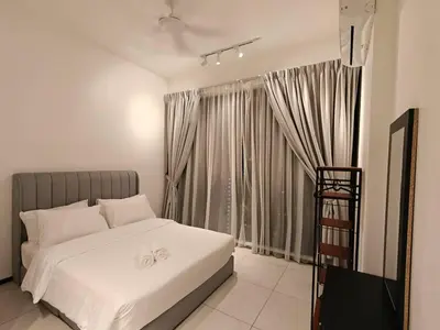 a bedroom with a white bed and a window at Urban Suites Georgetown Penang - Affordable & Cozy Stay with High Floor-Sea & Penang Bridge View in George Town