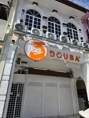 a building with a sign on the side of it at The Ipohstay hostel in Ipoh