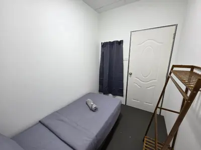 a room with a bed and a ladder and a door at The Ipohstay hostel in Ipoh