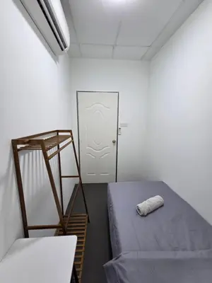 a room with a bed and a ladder and a door at The Ipohstay hostel in Ipoh