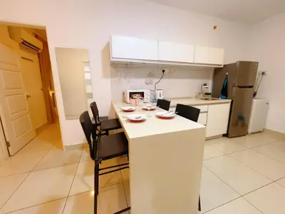 a kitchen with a white island in a room at Mansion one premium suite-2 bedroom in George Town