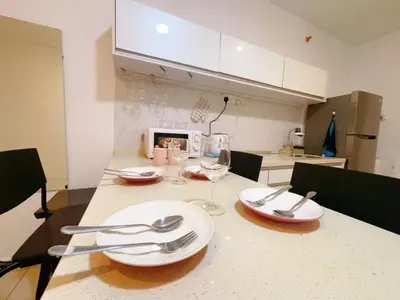 a kitchen with a table with plates and wine glasses at Mansion one premium suite-2 bedroom in George Town