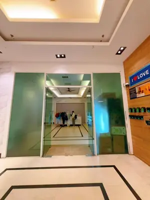 a lobby of a building with people in the background at Mansion one premium suite-2 bedroom in George Town