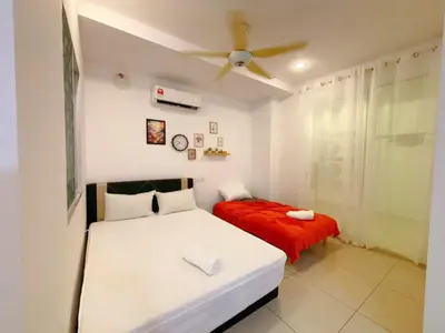 a bedroom with two beds and a ceiling fan at Mansion one premium suite-2 bedroom in George Town
