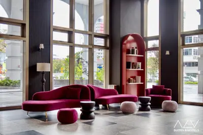 a living room with purple furniture and large windows at 22 Macalisterz by ALV in George Town