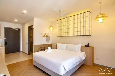 a bedroom with a large white bed and a ceiling fan at 22 Macalisterz by ALV in George Town