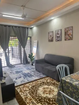 a living room with a couch and a table at Homestay Bonda E in TanjongMalim