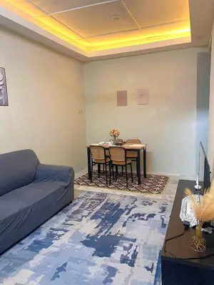 a living room with a couch and a table at Homestay Bonda E in TanjongMalim