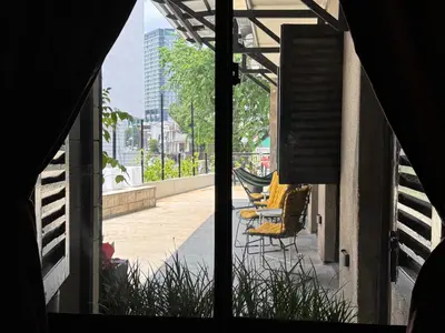 a view from a window of a patio with chairs at Miner's House Ipoh in Ipoh