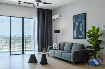 a living room with a couch and a large window at Sunshine Residence Suites in Ayer Itam