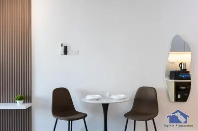 a table and two chairs in a room at Sunshine Residence Suites in Ayer Itam