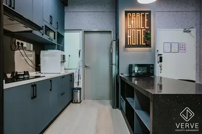 a large kitchen with a counter and a refrigerator at Ipoh Residence PR1MA Kepayang 6 pax suites in Ipoh