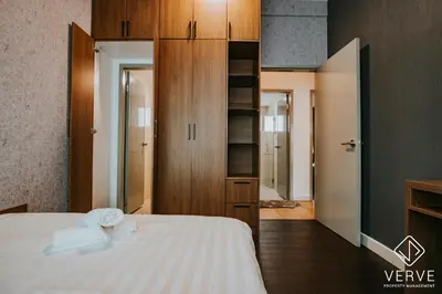 a bedroom with a bed with two towels on it at Ipoh Residence PR1MA Kepayang 6 pax suites in Ipoh