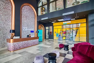 a store lobby with purple chairs and a counter at 22 Macalisterz Premium Suites Penang by BYON in George Town