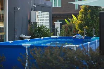 a large blue hot tub in a yard at The Nook Holiday Home Cozy, Stylish, Swimming Pool in Ipoh