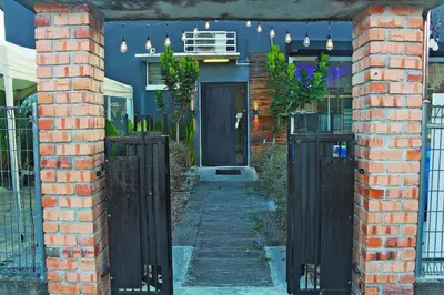 a blue house with a black door and a fence at The Nook Holiday Home Cozy, Stylish, Swimming Pool in Ipoh