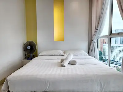 a bedroom with a large white bed with a window at The Tiny Treasure Stay #1BR in George Town