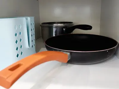 a black pan sitting on top of a stove at The Tiny Treasure Stay #1BR in George Town