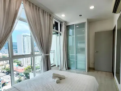 a bedroom with a bed and large windows at The Tiny Treasure Stay #1BR in George Town