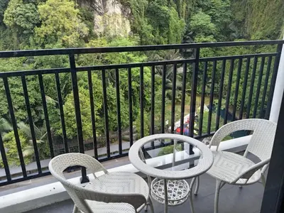 a balcony with chairs and a table on a balcony at The Cove 4-7 pax in Ipoh
