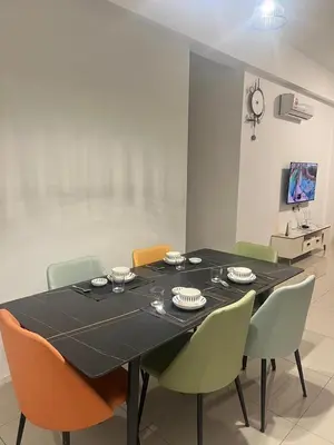 a dining room with a black table and chairs at The Cove 4-7 pax in Ipoh