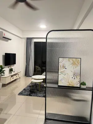 a living room with a couch and a tv at The Cove 4-7 pax in Ipoh