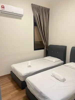 two twin beds in a room with a window at The Cove 4-7 pax in Ipoh
