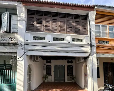 a white building with a window and a door at Toh Aka Inn in George Town
