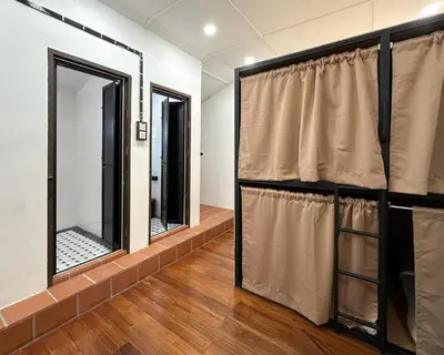 a room with three windows and a curtain at Toh Aka Inn in George Town