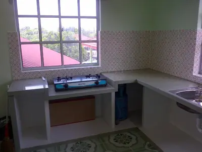 a small kitchen with a sink and a stove at Penang Green Homestay in Permatang Pauh
