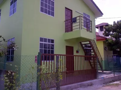 a house with a staircase in front of it at Penang Green Homestay in Permatang Pauh