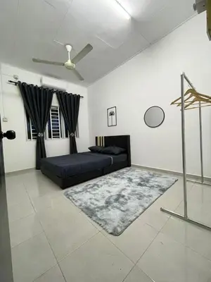 a living room with a couch and a rug at Homestay Bonda F in TanjongMalim