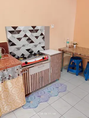 a kitchen with a counter with a toy train on it at Homestay Bait Al-Sakinah in Simpang Ampat