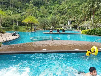 a man is in a swimming pool at The Haven Resort 3 rooms renovated suite in Tambun