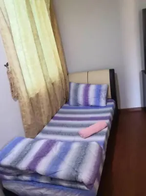 a room with two beds with pillows and a window at The Haven Resort 3 rooms renovated suite in Tambun