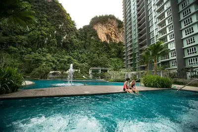 a group of people sitting in a pool with buildings at The Haven Resort 3 rooms renovated suite in Tambun