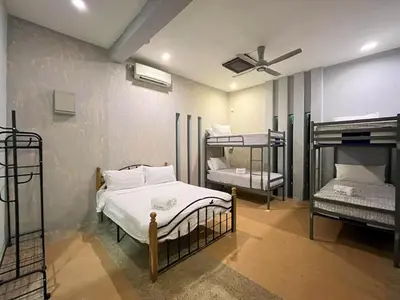 a room with three bunk beds and a ceiling fan at Cabin in the Valley in Tambun