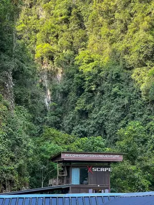 a train station with a sign in front of a mountain at Cabin in the Valley in Tambun