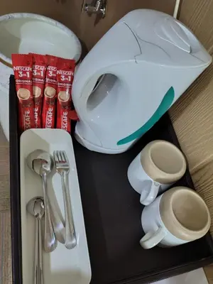 a tray with a toilet and utensils on it at QALSHARYNA CHALET inn in Taiping