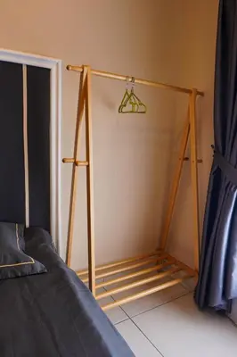 a room with a closet with a hanger and a bed at Horizon Ipoh 8Pax 3R2B - Tropical Bird's Retreat in Ipoh