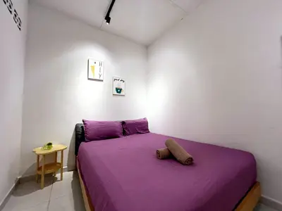 a bedroom with a bed with purple sheets and a table at Vintage Comfort 3Bedroom Haus in Lunas
